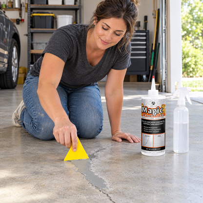 Woman smoothing crack filler on a garage floor with a scraper