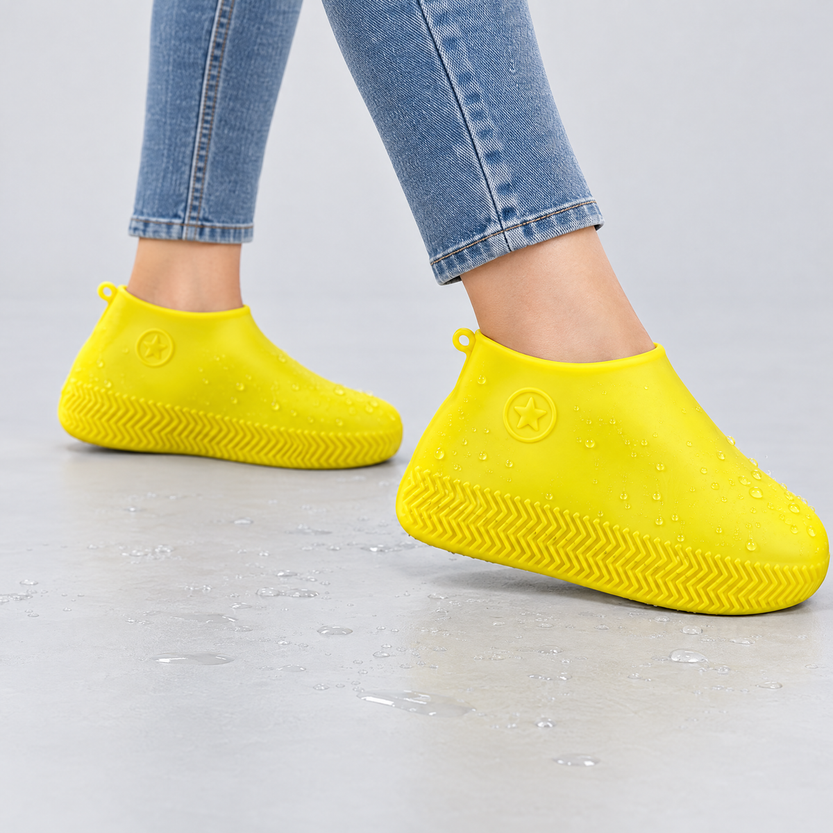Yellow silicone waterproof shoe covers worn over shoes