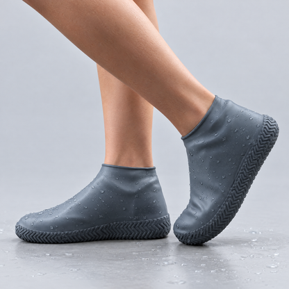 Grey silicone waterproof shoe covers worn over shoes