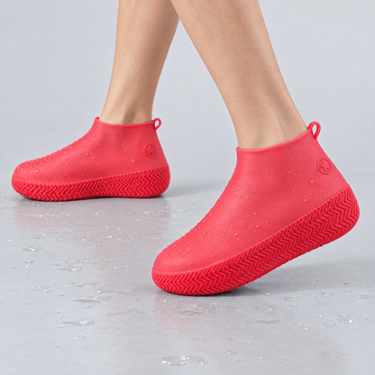 Pink silicone waterproof shoe covers worn over shoes