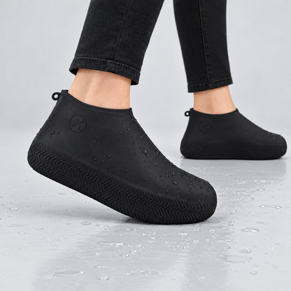 Black silicone waterproof shoe covers worn over shoes