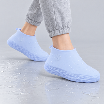 Blue silicone waterproof shoe covers worn over shoes