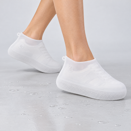 White silicone waterproof shoe covers worn over shoes
